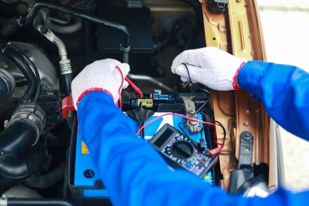 Mechanic checking car electric system
