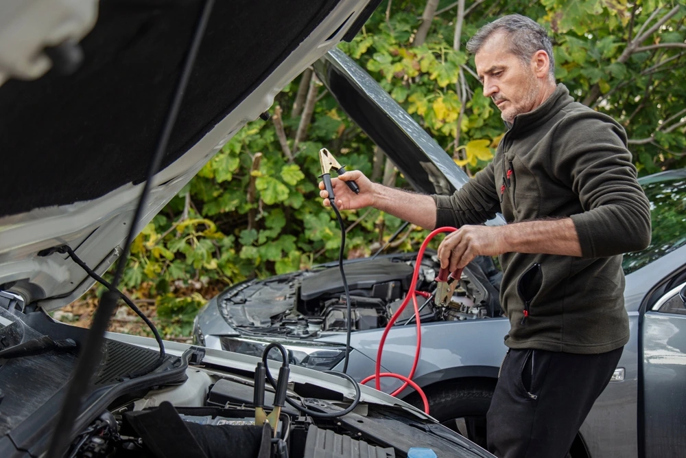 man charging car battery Insulated wires