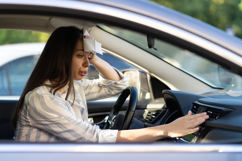young woman Exhausted from heat in car